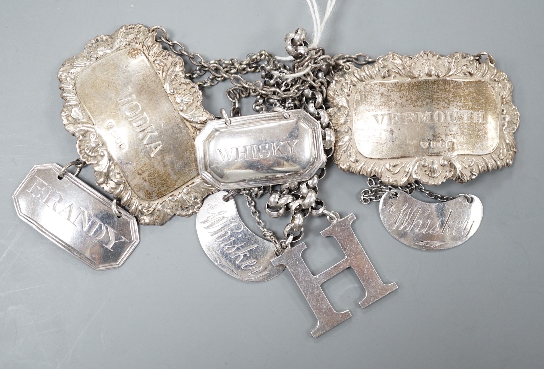 Seven assorted Georgian and later silver wine labels, including Scottish 'H', Robert Gray & Sons, Glasgow, 1837.